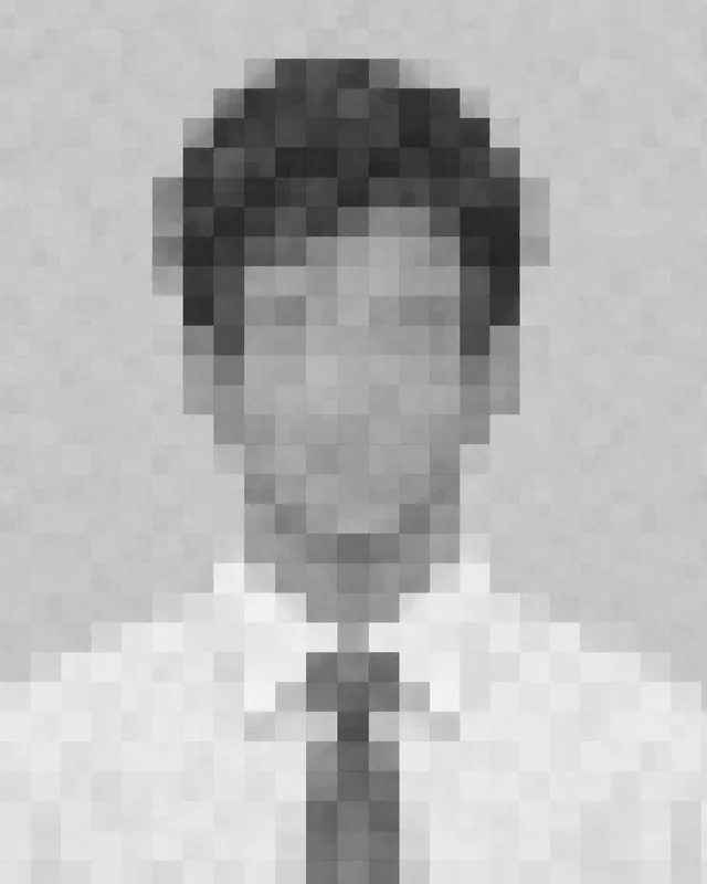 Rodney’s anonymous personnel portrait: a coarse grayscale mosaic suggesting dark hair, a white dress shirt and a gray tie.