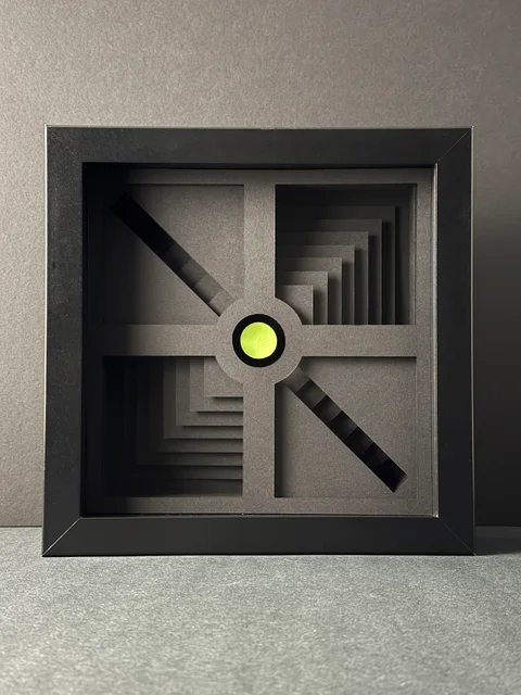 NF-01, a dark framed paper relief with stepped recesses and a lime circular center.