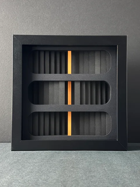 NF-03, a dark rectangular paper relief with rounded openings and a vertical orange core.