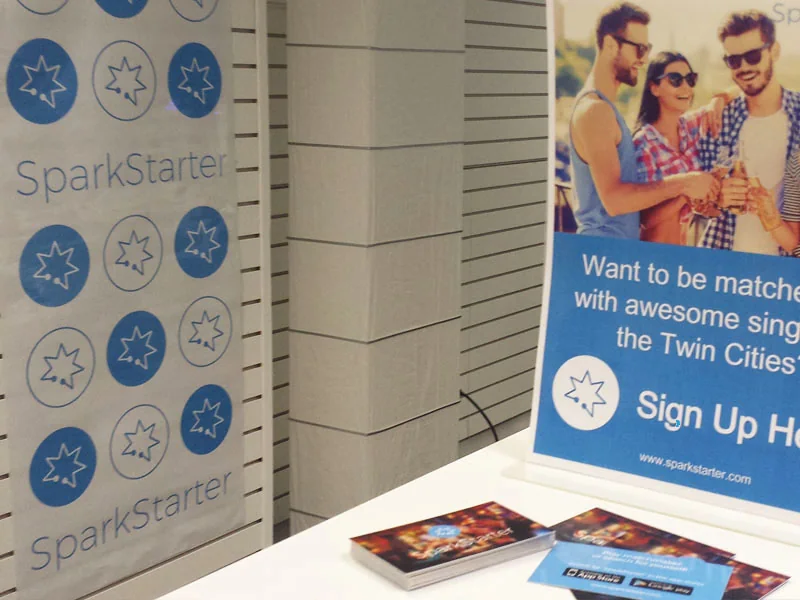 SparkStarter pull-up banners and printed business cards on a table at a PR event