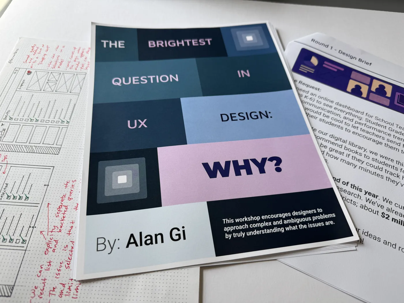 Printed UX workshop materials — the "Brightest Question in UX Design: Why?" booklet beside a hand-annotated wireframe critique and a Round 1 design brief handout